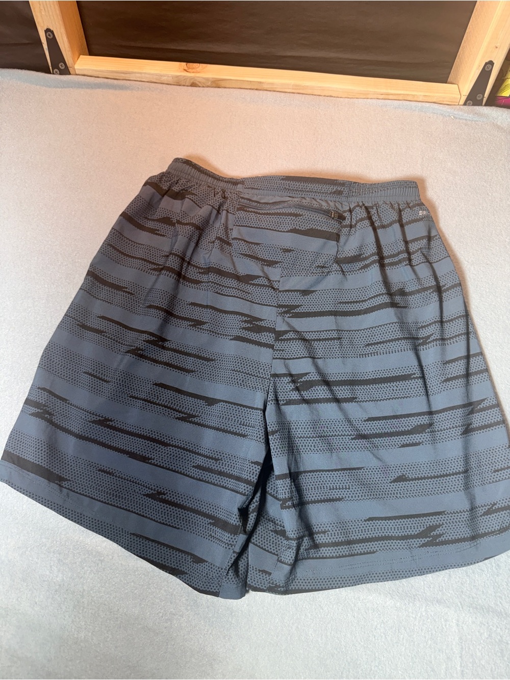 Nike Men's Gray Athletic Shorts with Black Stripe Pattern